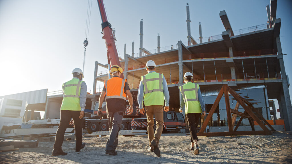 Diverse Team of Specialists Inspect Commercial, Industrial Building Construction Site.