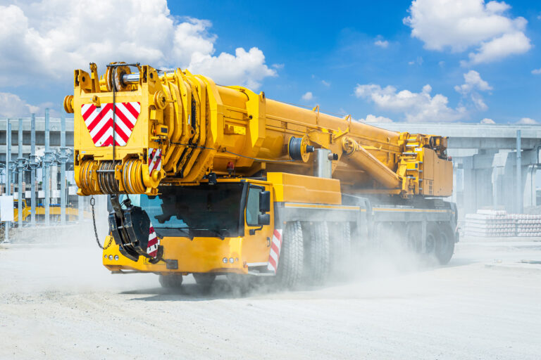 Mobile crane with cloudy sky.
